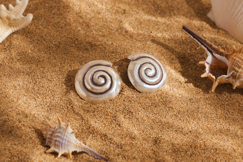 Raised spiral motif on a softly domed base.