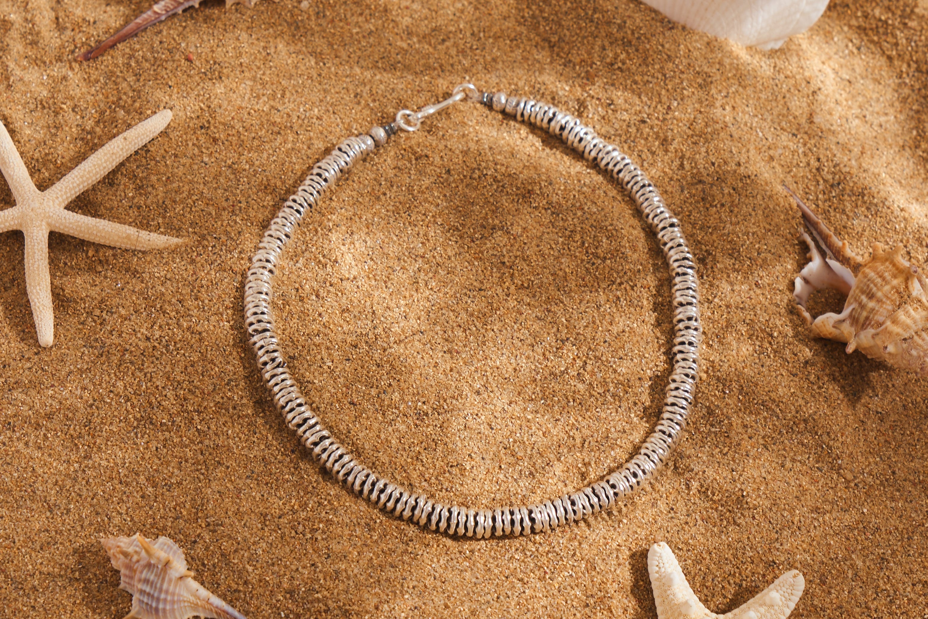 Hand-textured disc beads
Closure: Sturdy silver clasp.