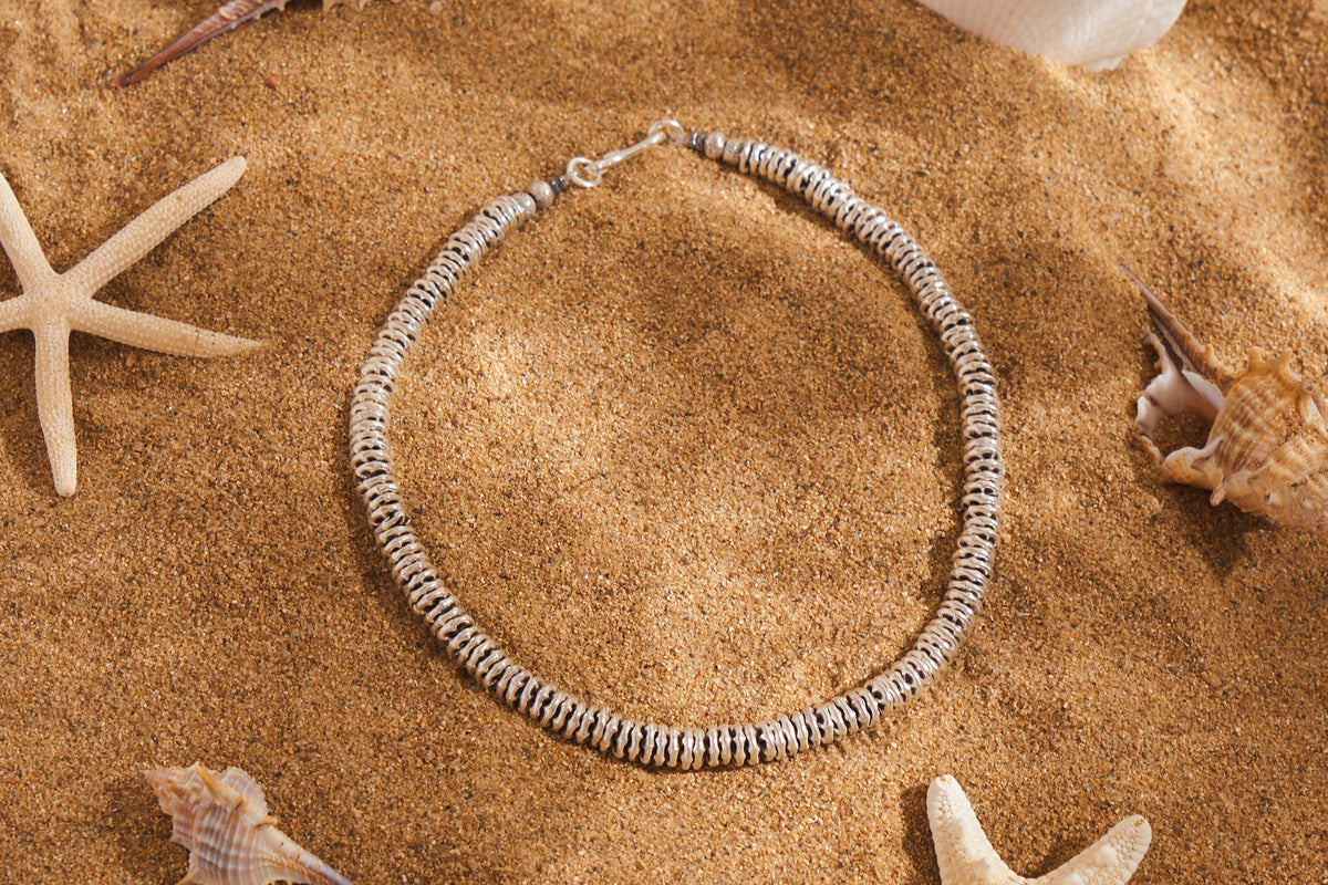 Hand-textured disc beads
Closure: Sturdy silver clasp.