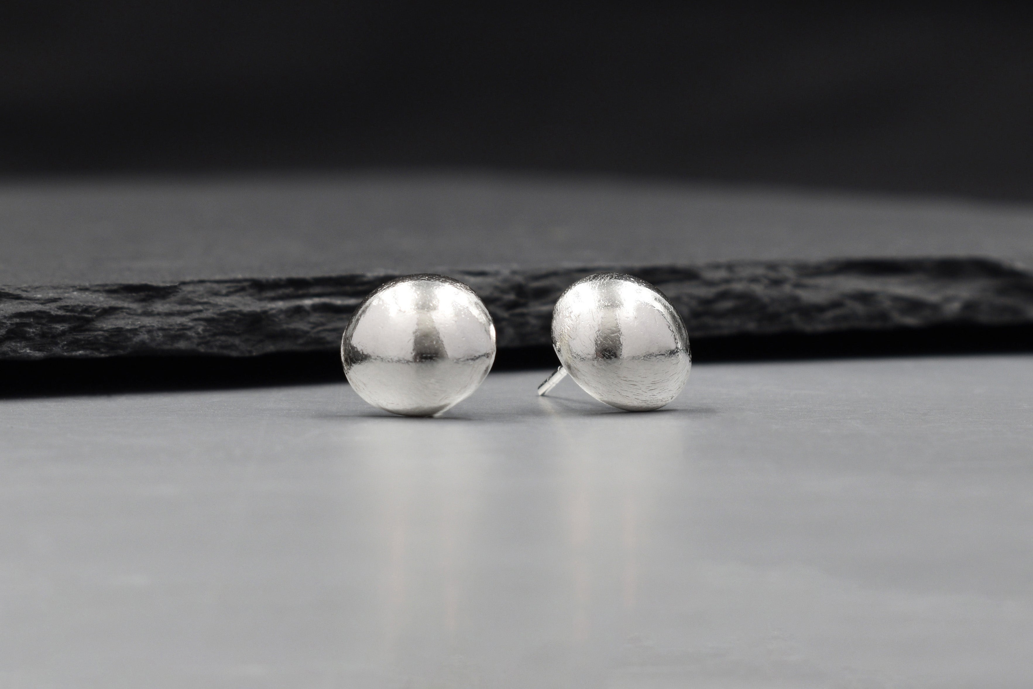 Solis Stud Earrings in pure silver showing a soft sculptural dome silhouette.