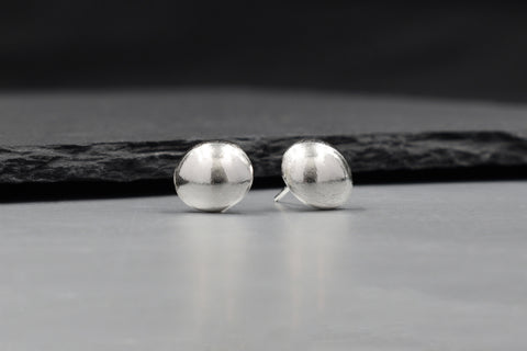 Solis Stud Earrings in pure silver showing a soft sculptural dome silhouette.