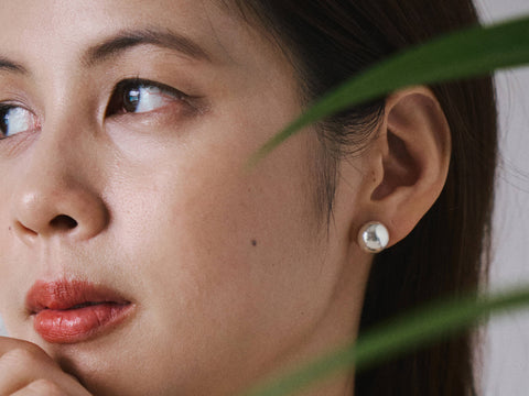 Model wearing Solis Stud Earrings, a minimal pure silver stud earring for everyday styling.