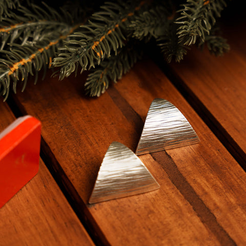 Renae Studs in pure silver showing tapered triangular form with brushed textured surface.