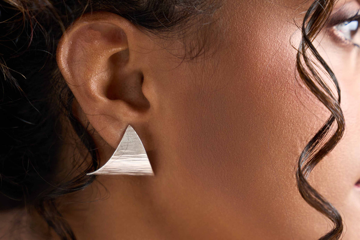 Model wearing Renae Studs, a sculptural pure silver stud earring for everyday styling.