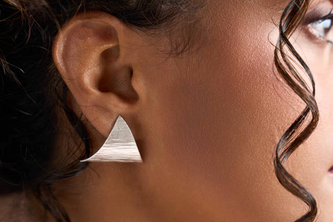 Model wearing Renae Studs, a sculptural pure silver stud earring for everyday styling.
