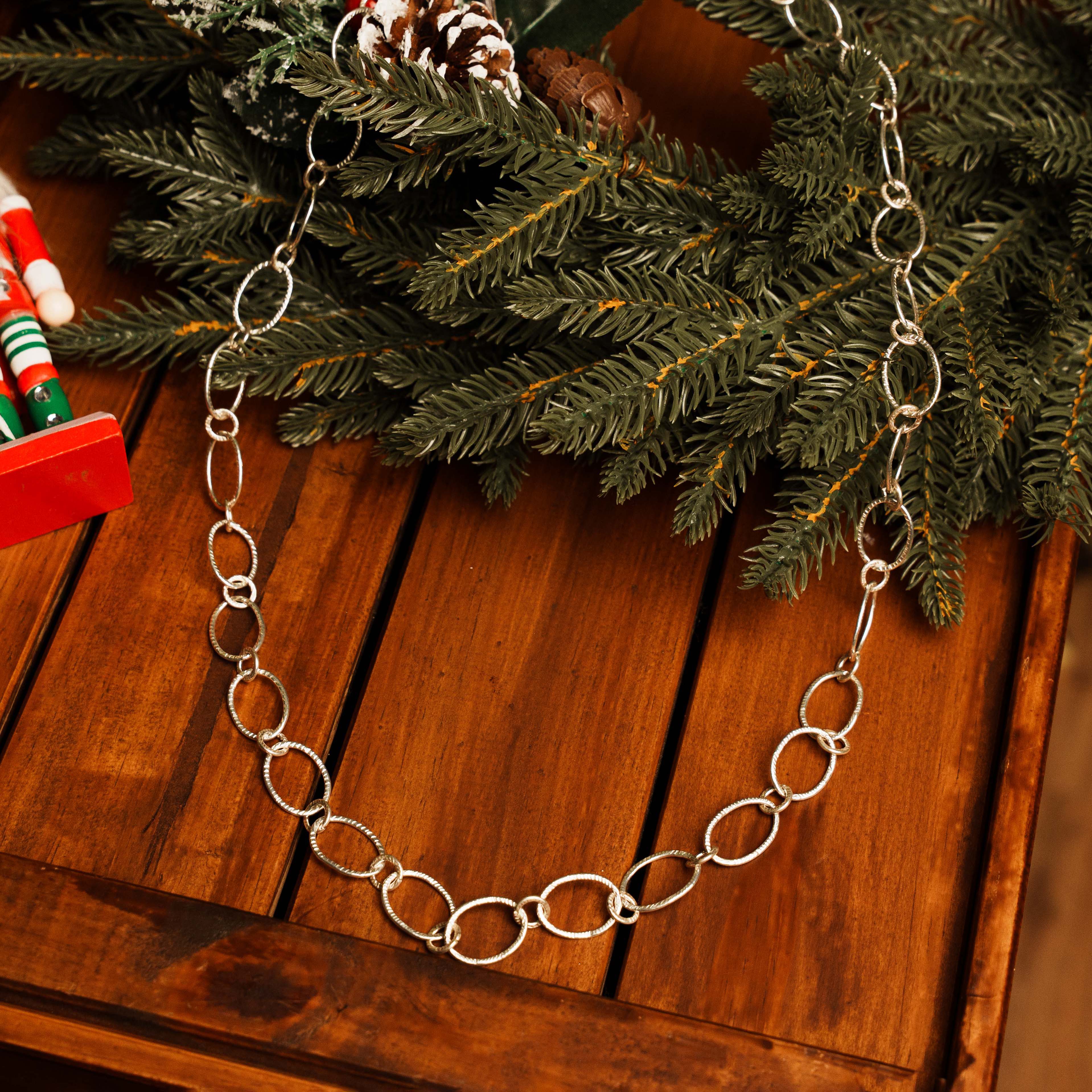 Cirra Link Necklace in pure silver showing alternating circle links draped at full length.