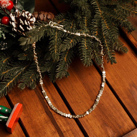 Zaria Necklace in pure silver showing flat oval beads with a soft natural shimmer.