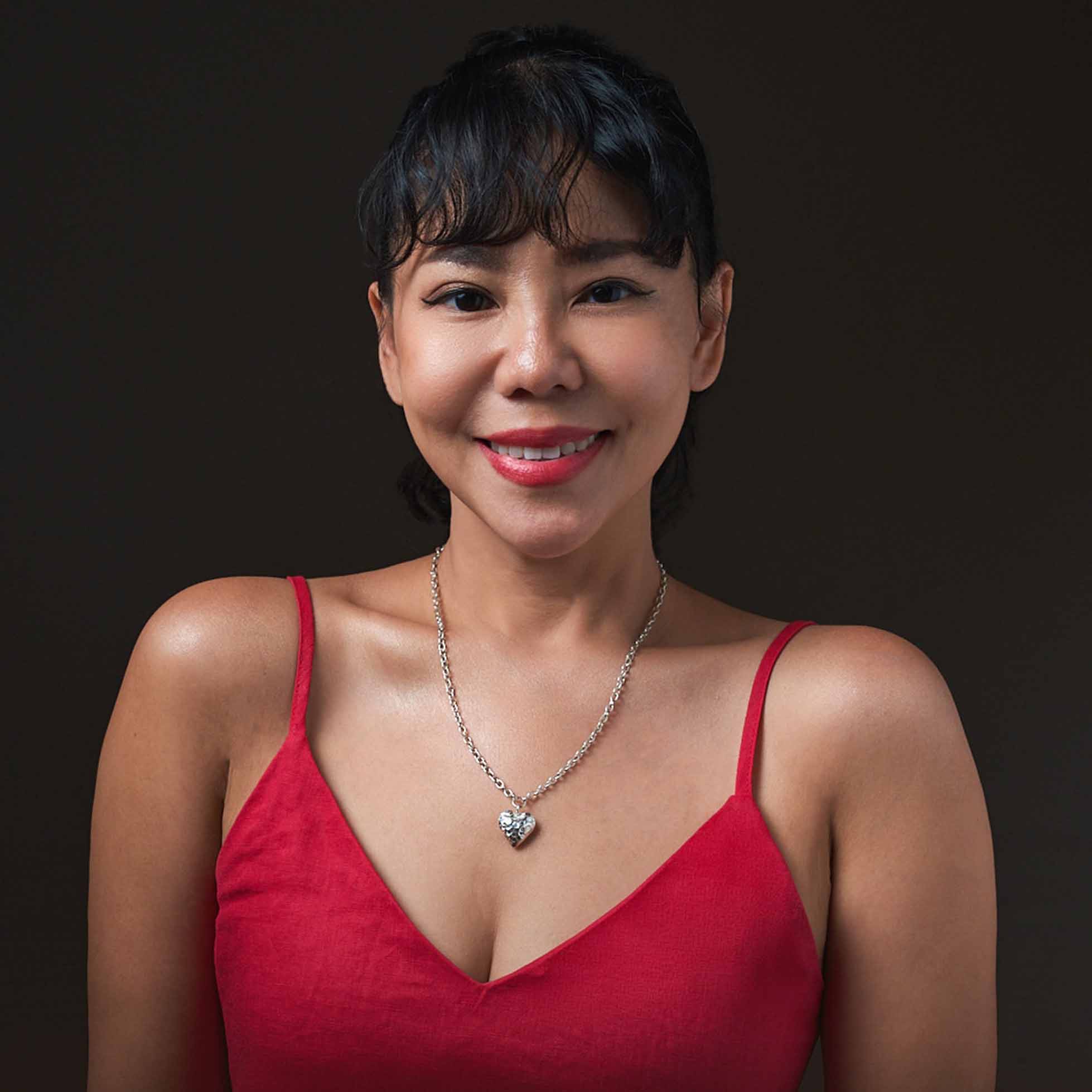 Model wearing Mira Heart Necklace, a minimalist pure silver heart necklace for everyday styling.