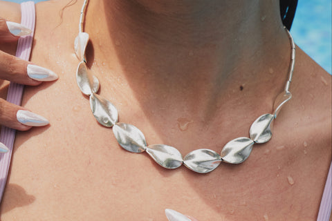 Close-up of Hamley Necklace showing smoothly sculpted wave-like beads and luminous pure silver finish.