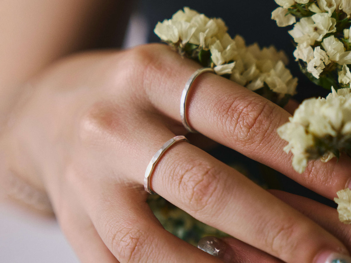 Lume Ring in pure silver showing subtle hammered texture detail.
