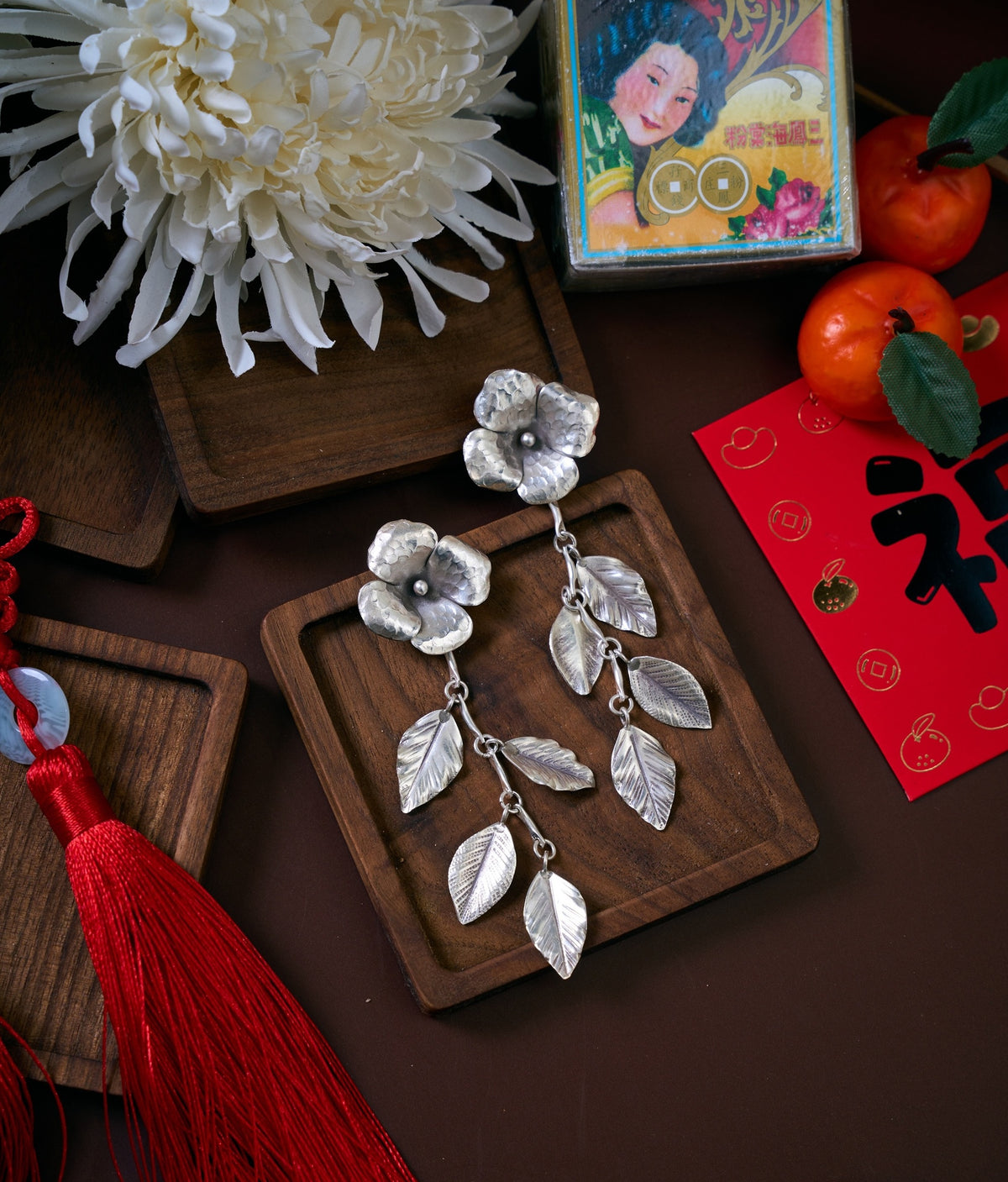 Shuyi Earrings in pure silver showing handmade floral petals and delicate leaf drops.