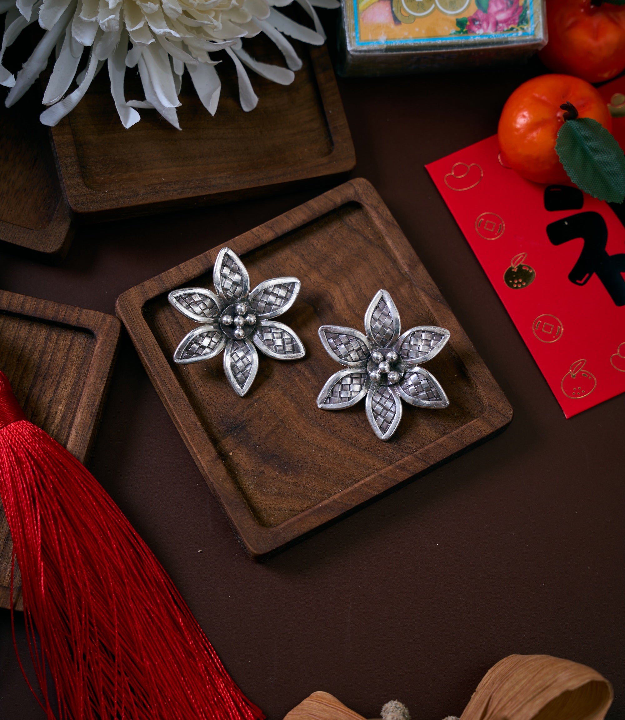 Xinya Earrings in pure silver showing handmade floral forms with finely textured petals and sculpted centre.