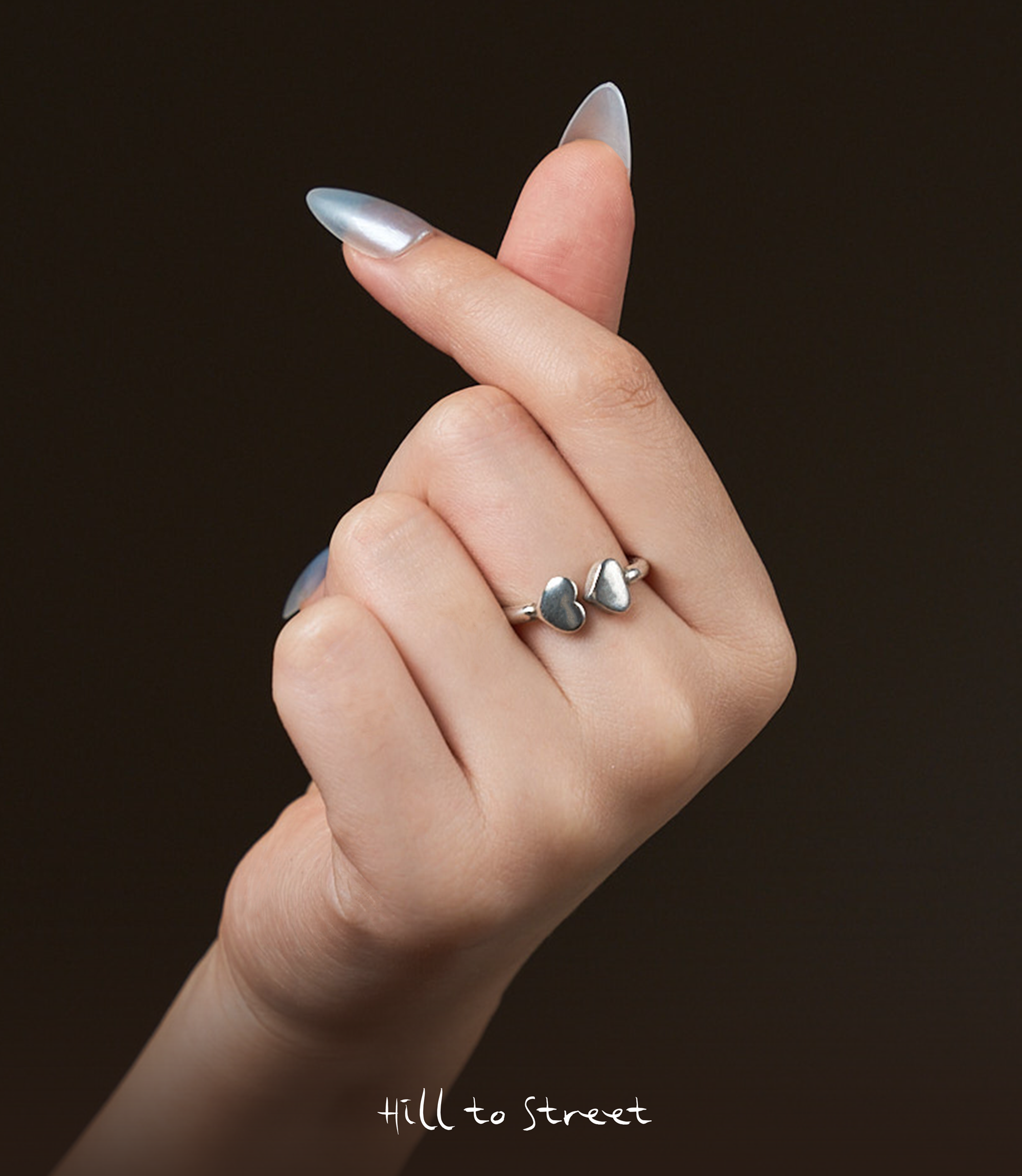 Model wearing Double Heart Ring, a minimalist pure silver heart ring for everyday styling.