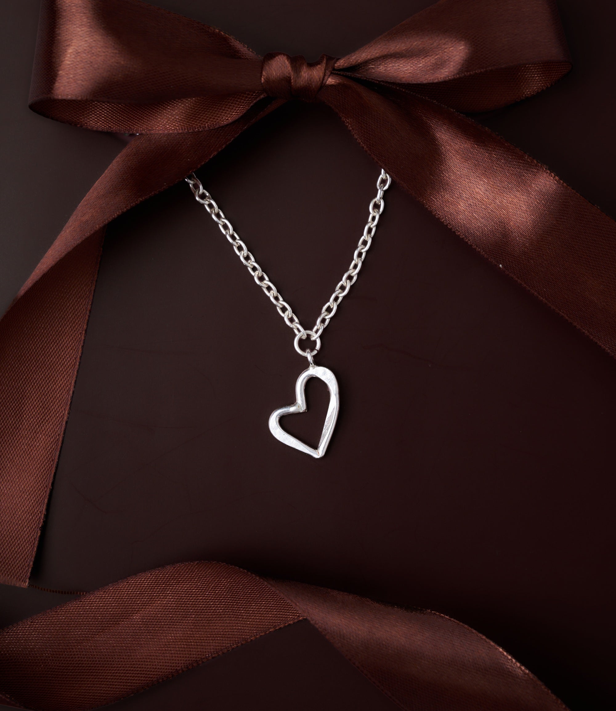 Close-up of Isabel pure silver heart necklace with minimalist design