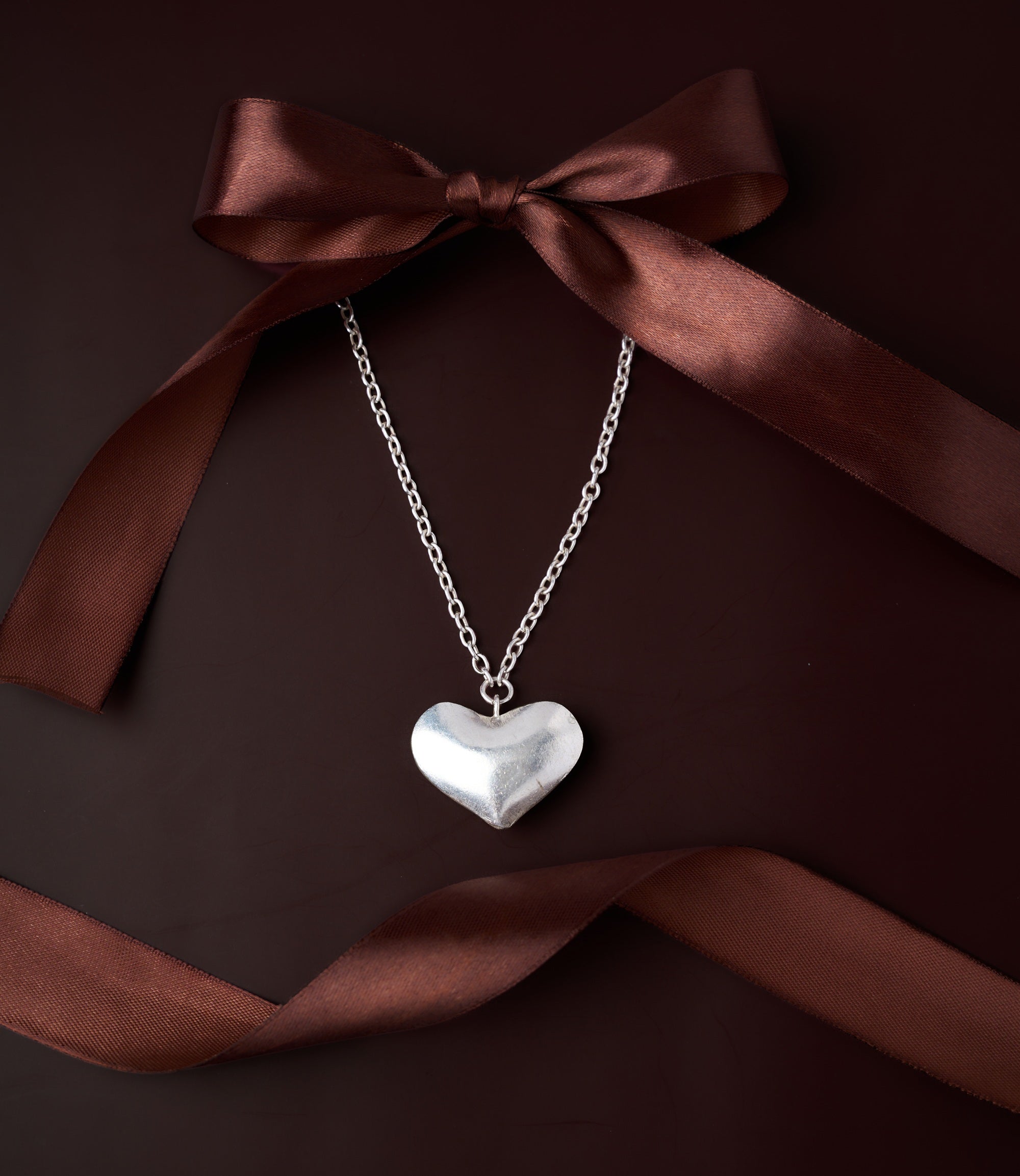 Lauren Heart Necklace in pure silver showing softly sculpted heart pendant with matte sheen.