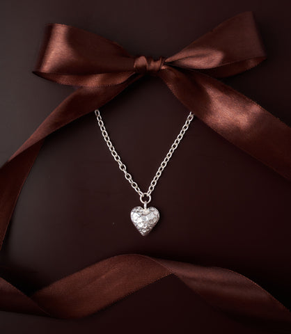 Mira Heart Necklace in pure silver showing softly hammered heart pendant on a delicate chain.
