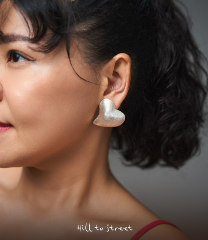 Model wearing Ari Heart Earrings, a bold yet minimalist pure silver heart earring for everyday styling.