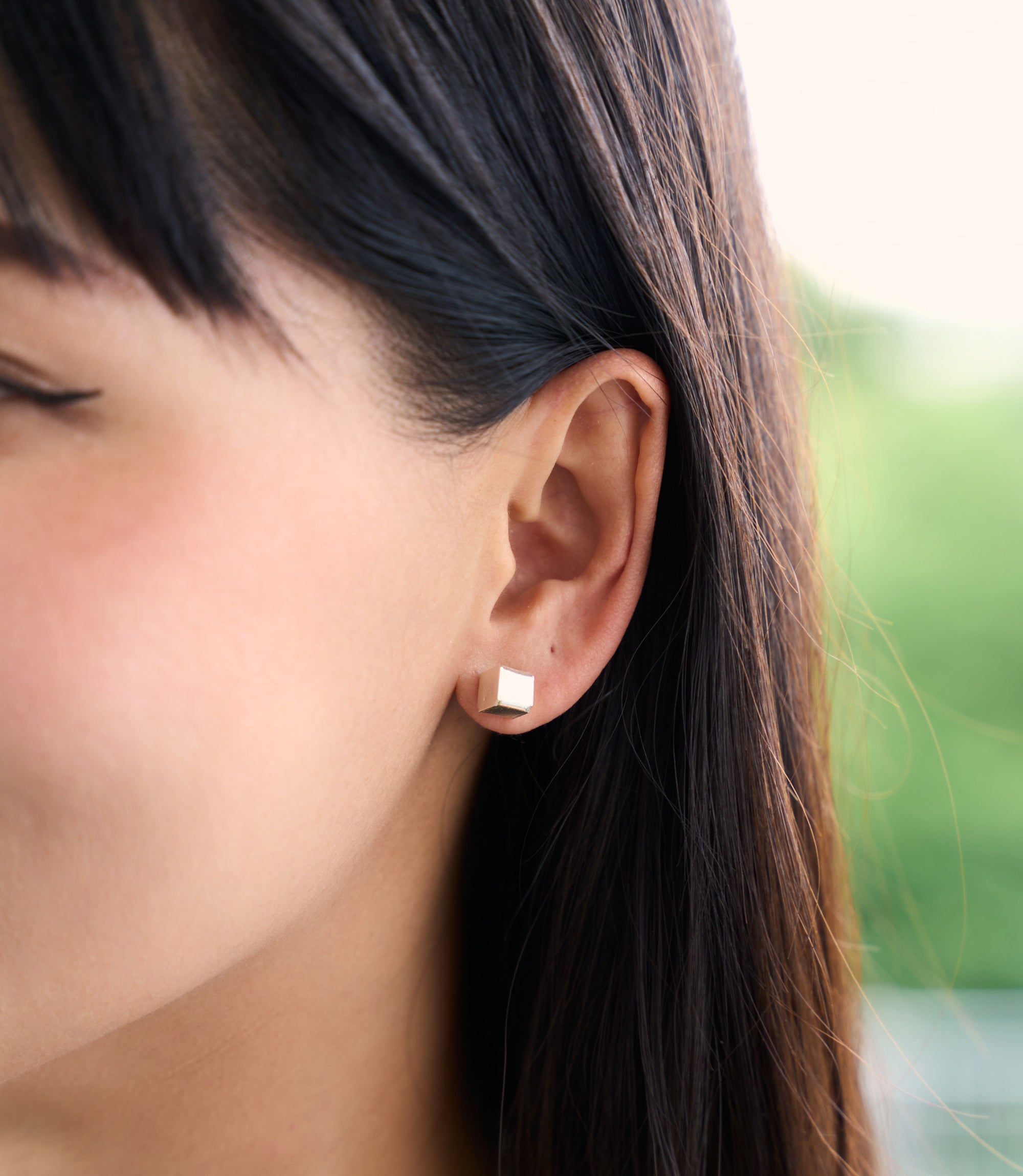 Aria Stud Earrings worn on ear in pure silver