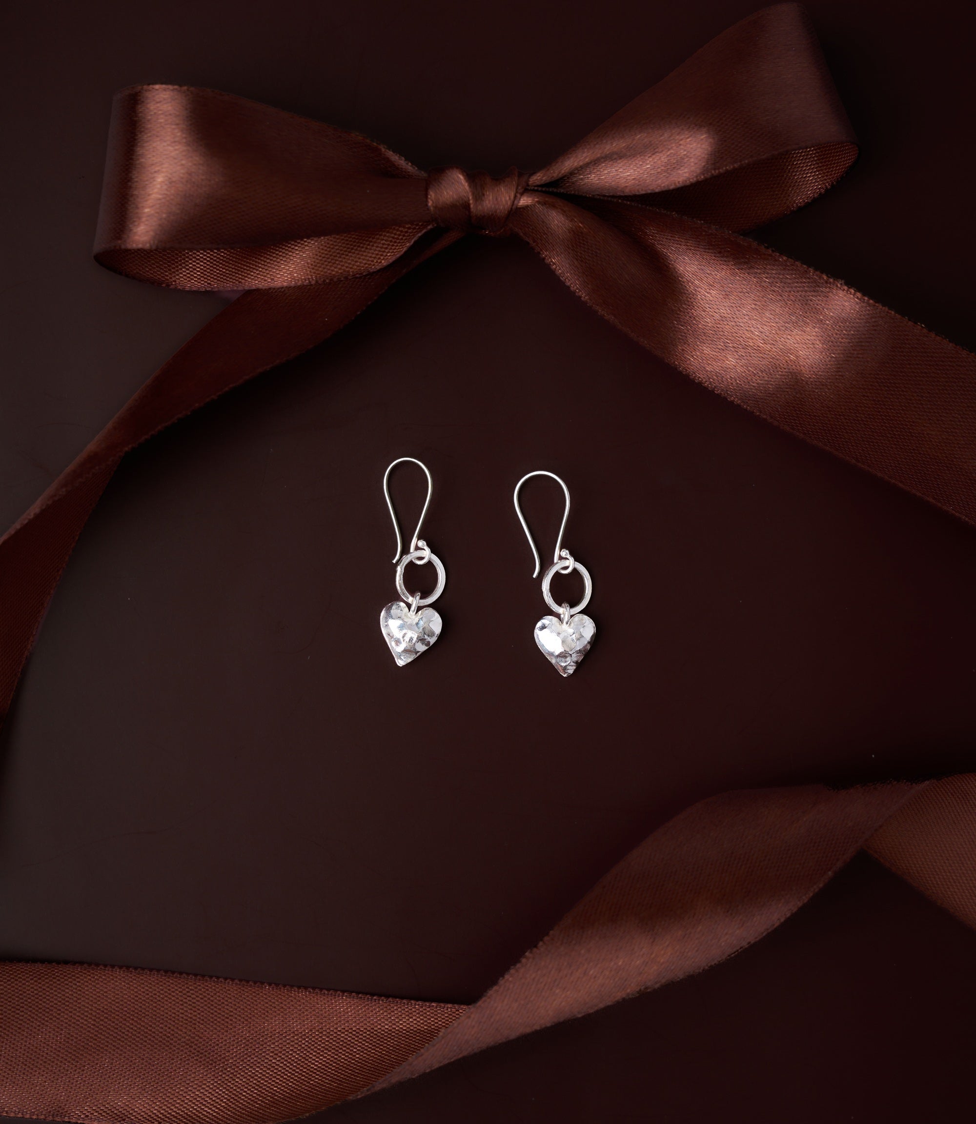 Elin Heart Drop Earrings in pure silver showing delicately hammered heart charm on fine silver loop.