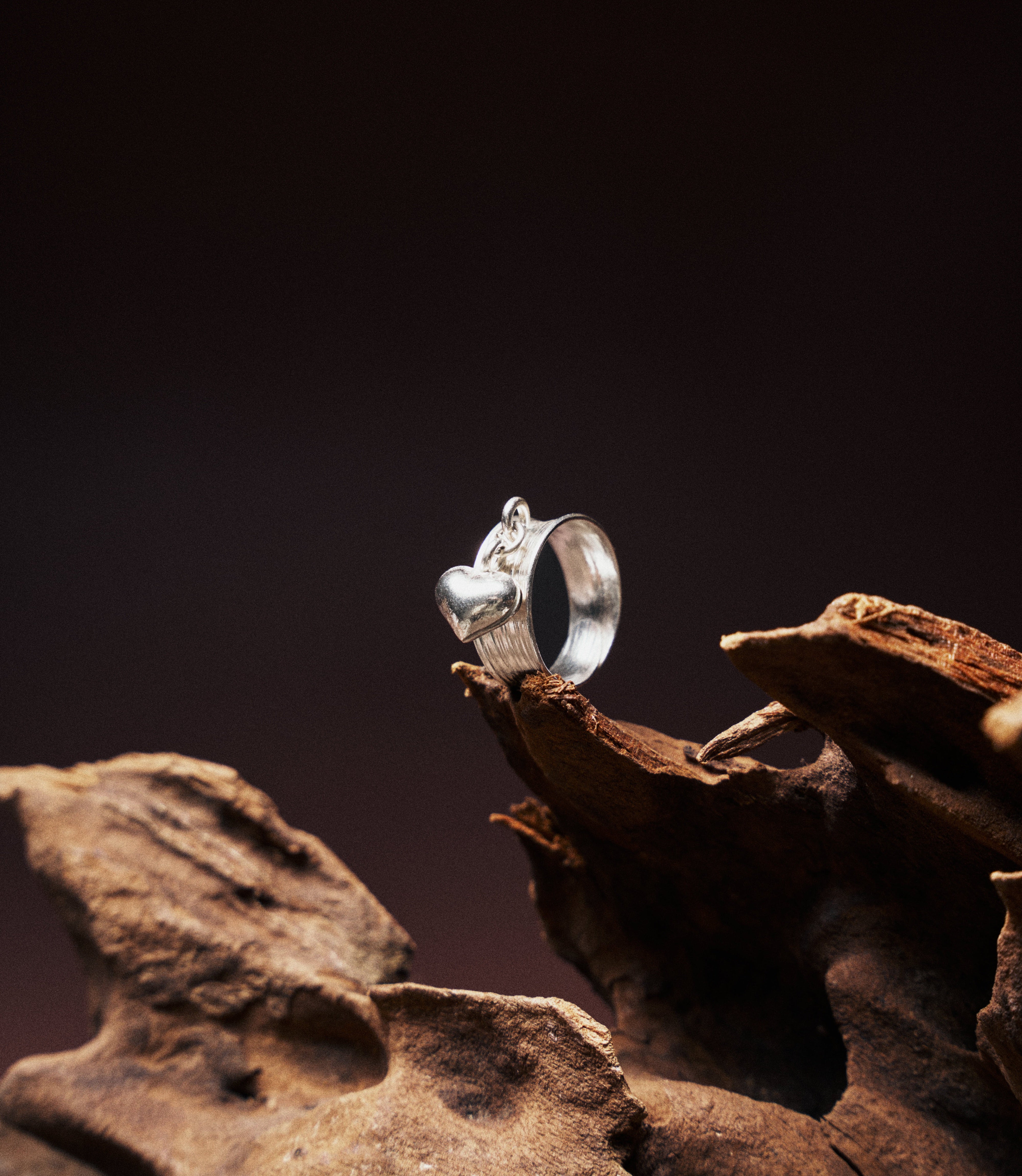 Heart Charm Band in pure silver showing textured band with dangling heart charm detail.