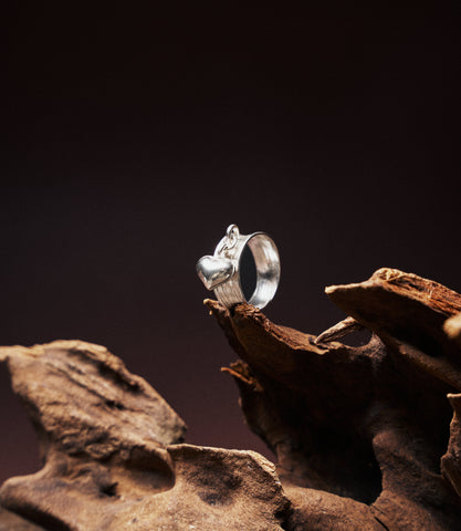 Heart Charm Band in pure silver showing textured band with dangling heart charm detail.