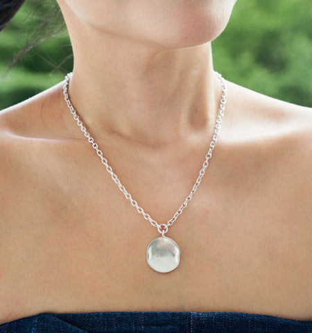 Model wearing the Noemi Necklace, a pure silver pendant necklace for everyday styling.
